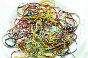 Elastic multicolored elastic bands lie on a table