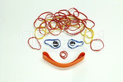 Funny face made of colorful rubber bands