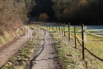 An electric fence along a field road