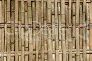 Wicker fence made of sawn bamboo trunks
