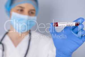 Nurse holding test tube with Positive Coronavirus test blood sam