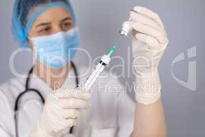 Doctor hands filling the syringe with vaccine