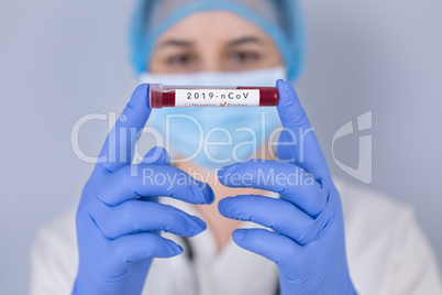 Nurse holding test tube with Positive Coronavirus test blood sam