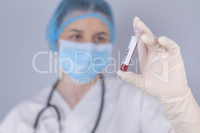 Nurse holding test tube blood sample