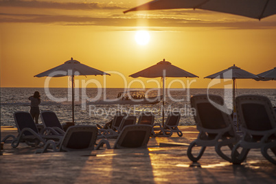 Parasols and sunbeds create a sunset silhouette 2