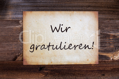 Old Paper, Wir Gratulieren Means Congratulations, Wooden Background