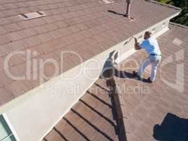 Professional Painter Using A Brush to Paint House Fascia