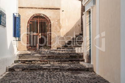 Ancient Cobblestone Walkway and Steps Among Building in Santorin