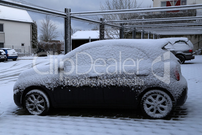 A Car covered with fresh white snow