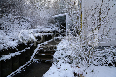 The path with steps at the house is cleared of snow