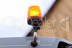 Orange flashing light on the transport on a blurred background