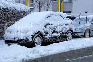 A Car covered with fresh white snow