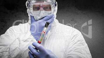 Male Doctor or Nurse In Hazmat Gear Holding Positive Coronavirus