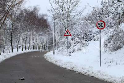 Winter landscape with road and road signs