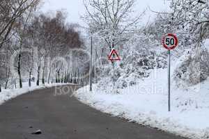 Winter landscape with road and road signs