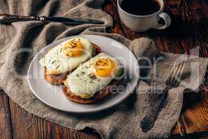 Toasts with vegetables and fried eggs with cup of coffee