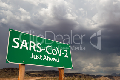 SARS-CoV-2 Coronavirus Green Road Sign Against Ominous Stormy Cl