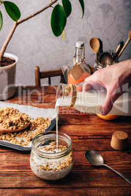 Man pouring milk on cereals