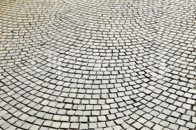 Abstract background of old cobblestone pavement close-up