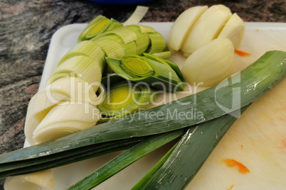 Chopped green onion cooked for lettuce, lies on the board
