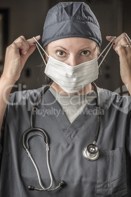 Female Doctor or Nurse with Stethoscope Putting On Protective Fa