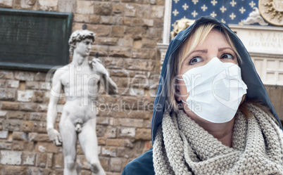Young Woman Wearing Face Mask Walks Near the Statue of David in