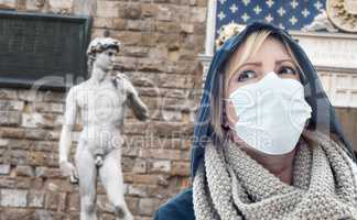 Young Woman Wearing Face Mask Walks Near the Statue of David in