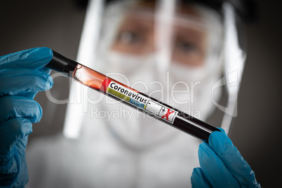 Female Lab Worker Holds Test Tube of Blood Labeled Coronavirus C