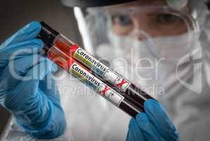 Female Lab Worker Holds Test Tubes of Blood Labeled Coronavirus