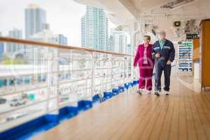 Senior Couple Walk Along Passenger Cruise Ship Deck Wearing Face