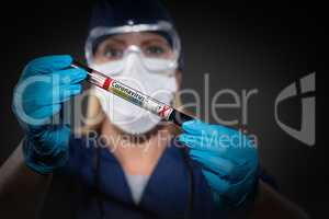 Female Lab Worker Holds Test Tube of Blood Labeled Coronavirus C