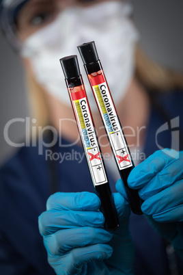 Female Lab Worker Holds Test Tubes of Blood Labeled Coronavirus