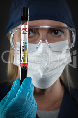 Female Lab Worker Holds Test Tube of Blood Labeled Coronavirus C