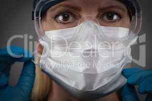 Female Medical Worker Wearing Protective Face Mask and Gear Agai
