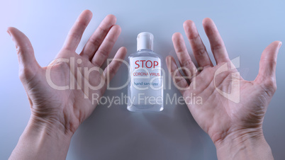 Using a bottle of hand sanitizer against viruses.