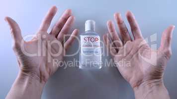 Using a bottle of hand sanitizer against viruses.