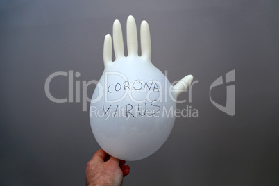 On a rubber glove it is written - coronovirus