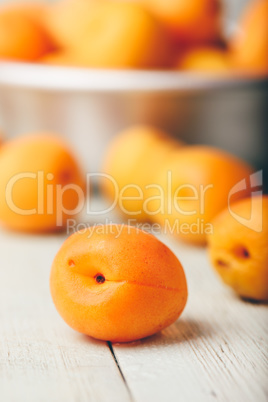 Mellow apricots over light wooden surface