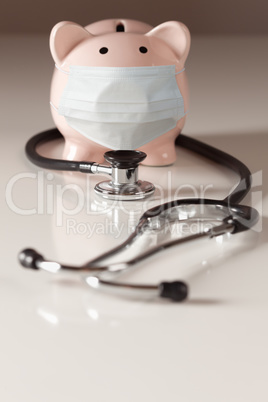 Stethoscope and Piggy Bank Wearing Protective Medical Face Mask.