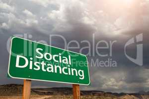 Social Distancing Green Road Sign Against Ominous Stormy Cloudy