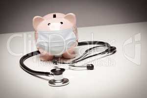 Stethoscope and Piggy Bank Wearing Protective Medical Face Mask