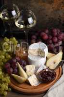 Antipasti. Cheese camembert with fruit and wine