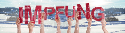 People Hands Holding Word Impfung Means Vaccination, Snowy Winter Background