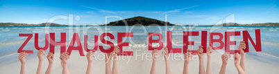 People Hands Holding Word Zuhause Bleiben Means Stay At Home, Ocean Background