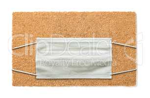 Blank Welcome Mat With Medical Face Mask Isolated on White Amids