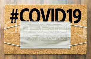 Welcome Mat With Medical Face Mask and #COVID19 Text Amidst The