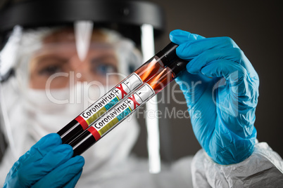 Female Doctor or Nurse Holding Test Tubes of Blood Labeled Posit