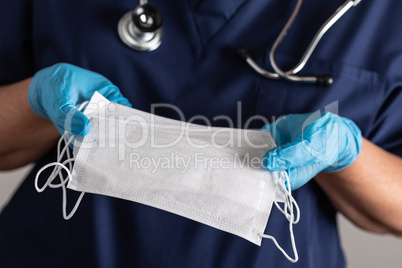 Female Doctor or Nurse Wearing Surgical Gloves Holding A Few Med