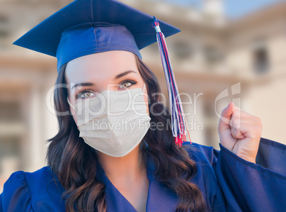 Female Graduate in Cap and Gown Wearing Medical Face Mask