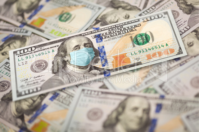 Pile of One Hundred Dollar Bills With Medical Face Mask on Face